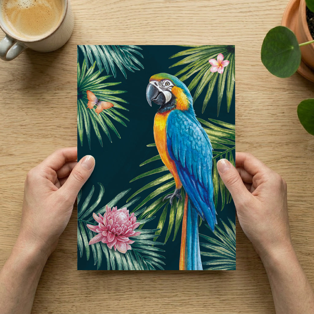 Person holding an art print with a colourful parrot design on a wooden table.