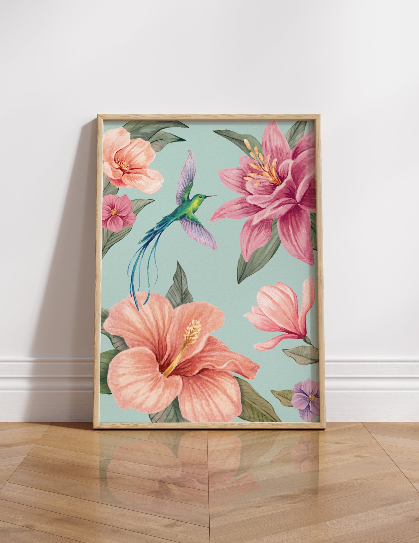 Framed artwork of pink flowers and a hummingbird on an aqua blue background
