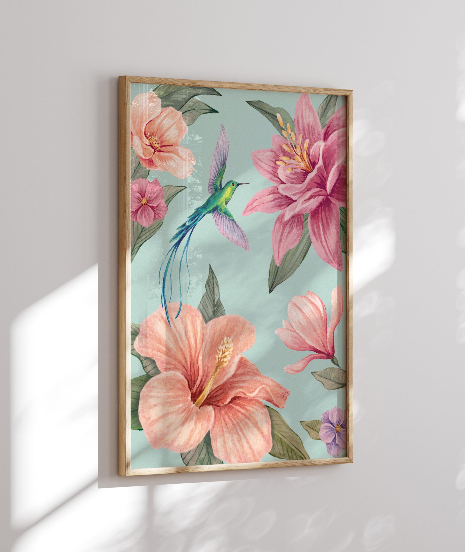 Framed artwork with pink flowers and a hummingbird on on an aqua blue background