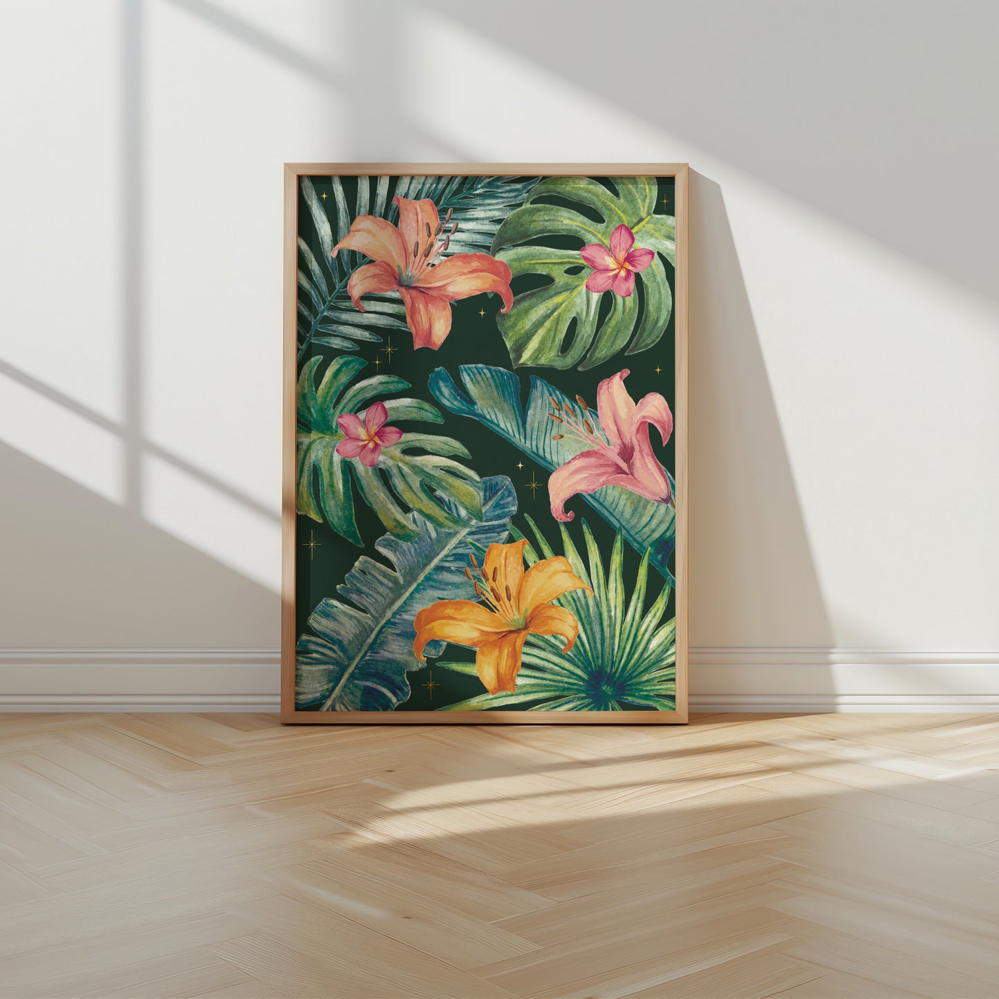Framed artwork of tropical flowers on a wall with sunlight casting shadows.