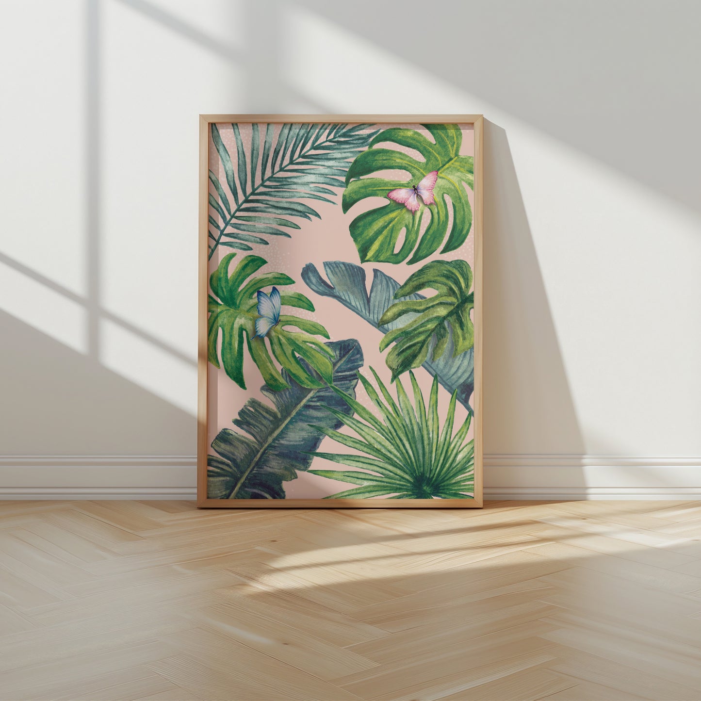 Framed artwork with tropical leaf design on a wall
