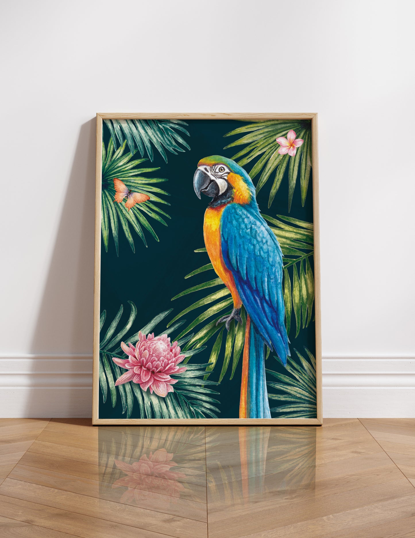 Framed artwork of a parrot and tropical leaves on a white wall.