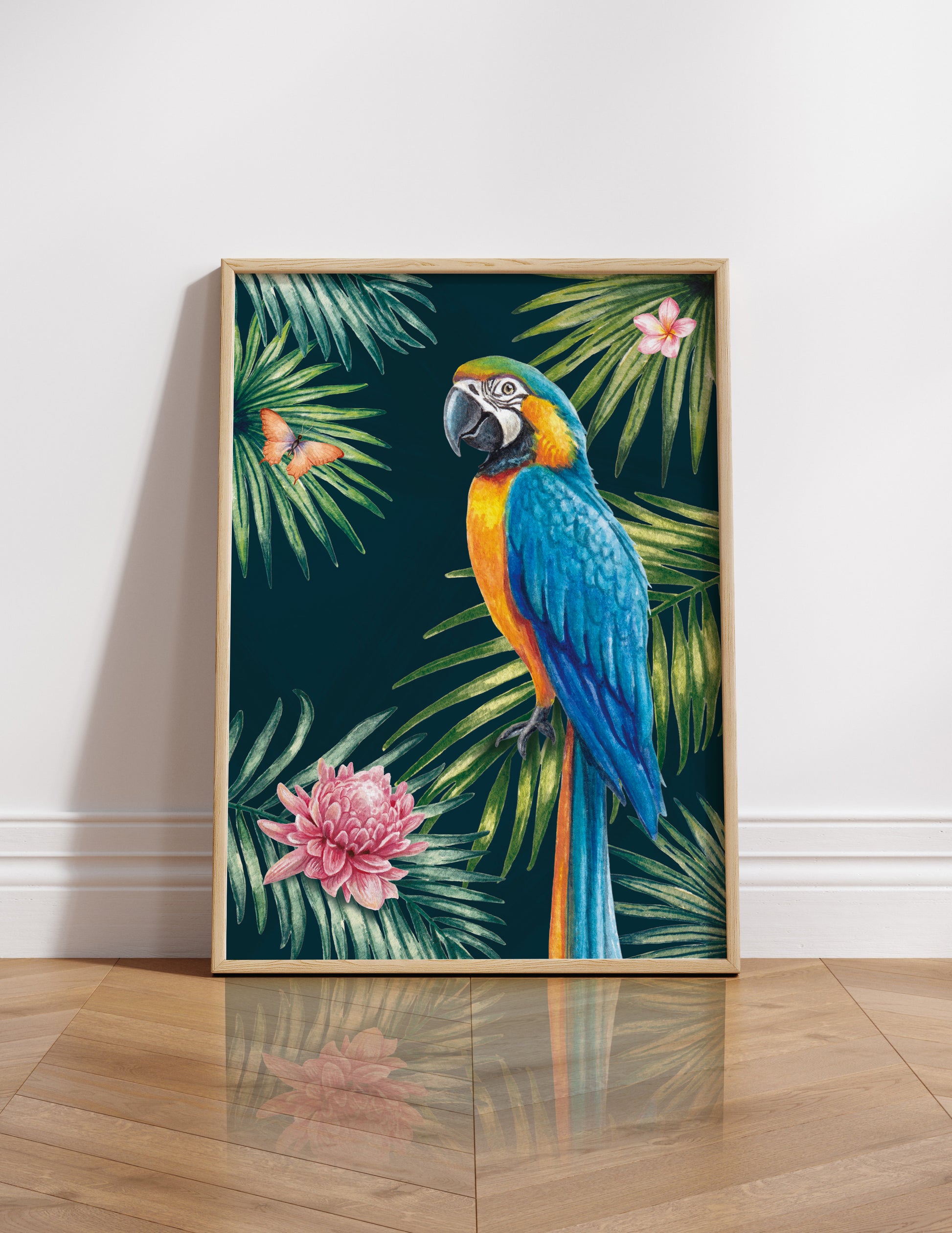 Framed artwork of a parrot and tropical leaves on a white wall.