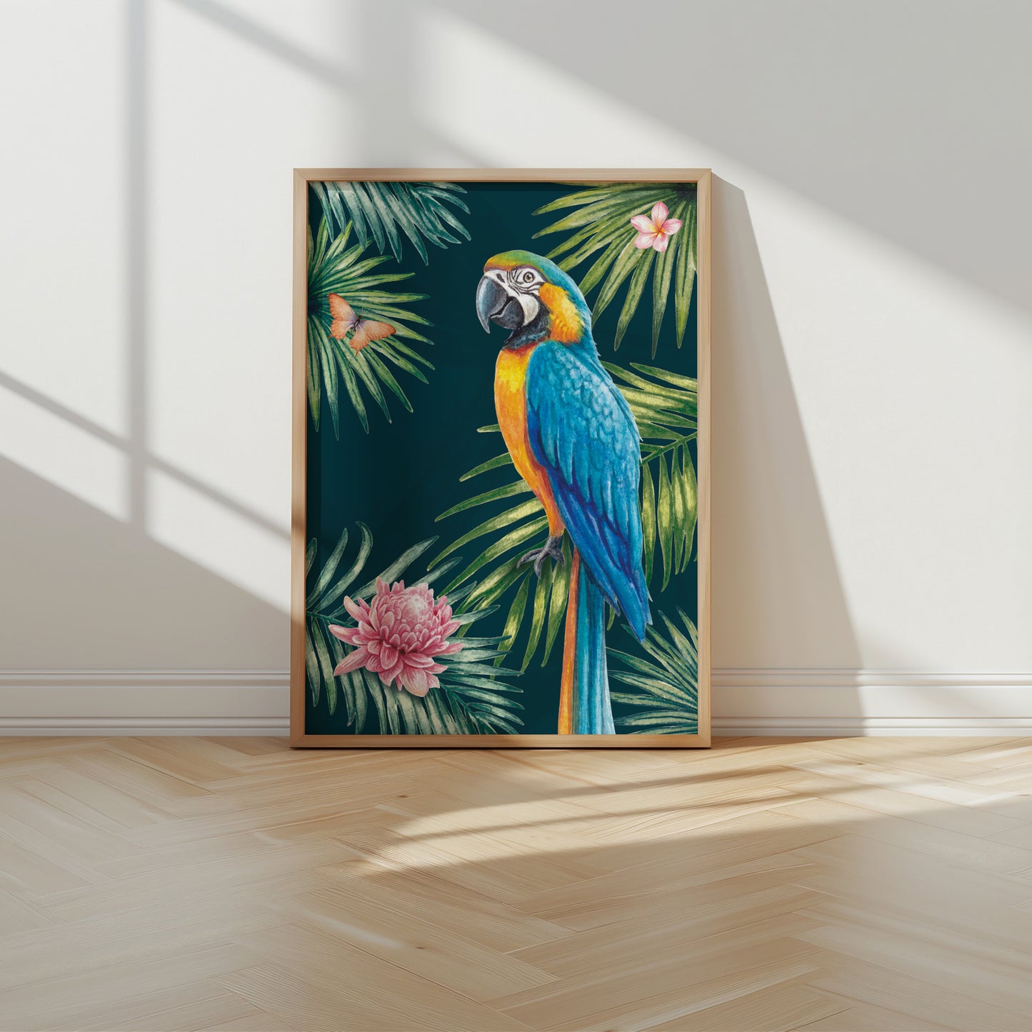 Framed artwork of a parrot and tropical leaves on a wall.