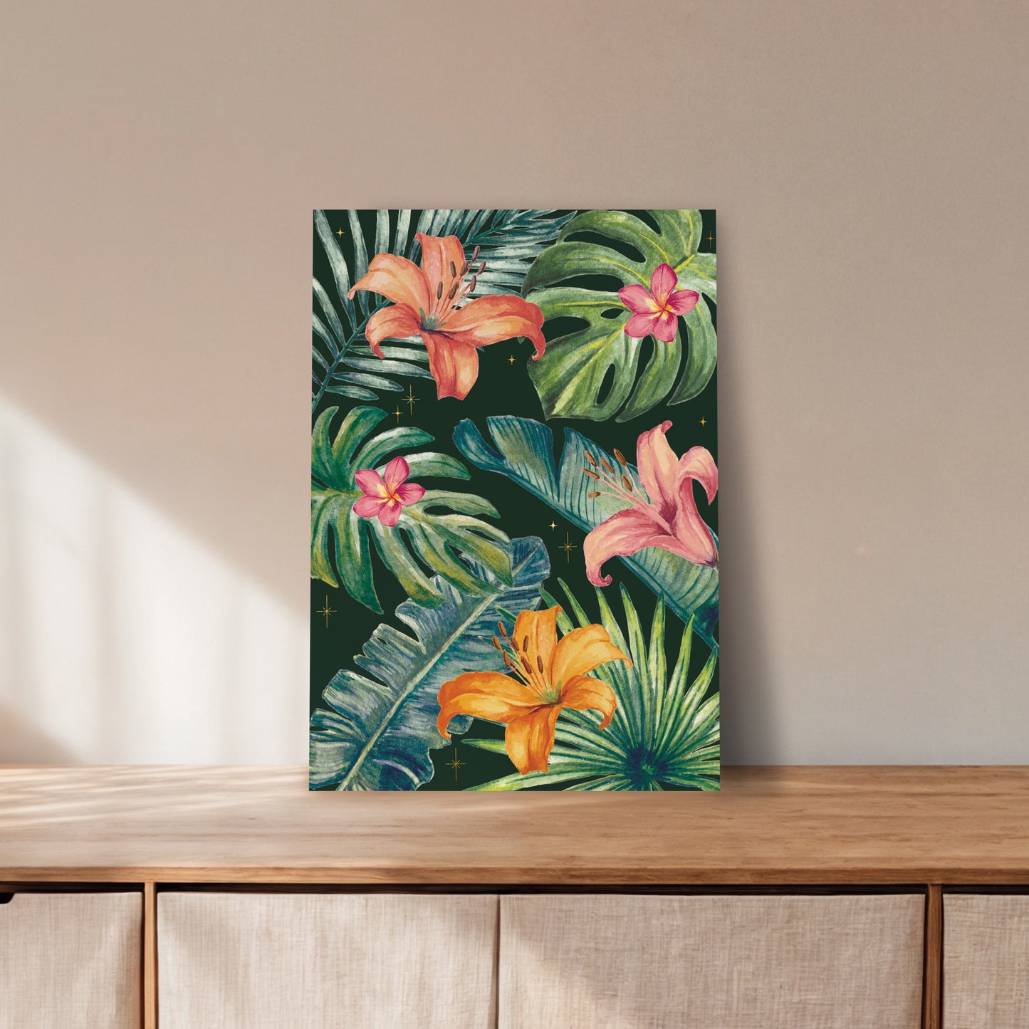 Art print with tropical flowers and leaves on a wooden surface.